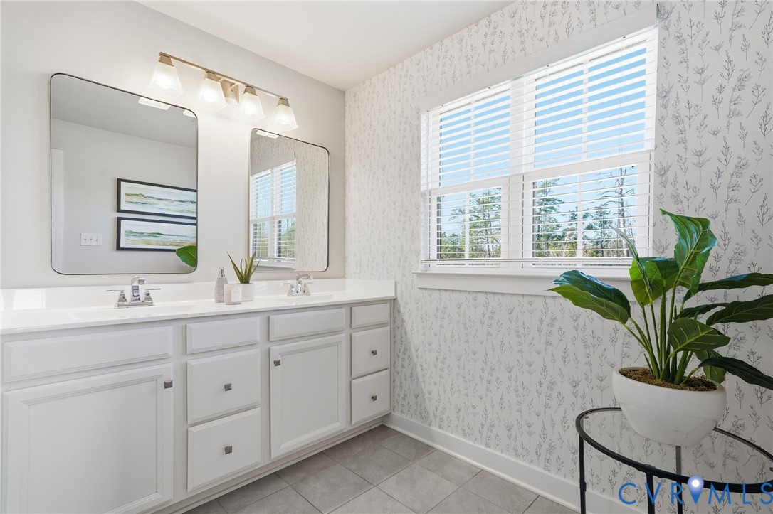 4730 Hepler Ridge Way Glen Allen, VA 23059 - Photo 26 of 39 a bathroom with a granite countertop sink a large mirror a and a window