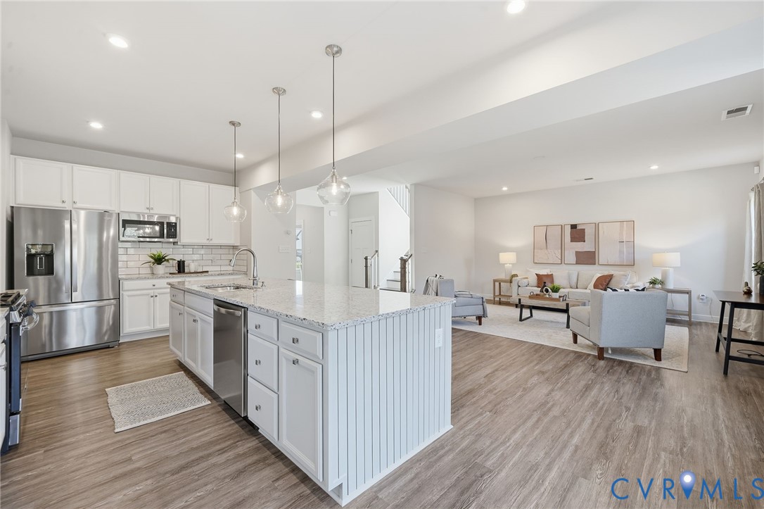 4730 Hepler Ridge Way Glen Allen, VA 23059 - Photo 7 of 39 a large kitchen with kitchen island a white cabinets and stainless steel appliances