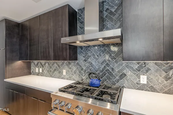 a kitchen with a stove and a cabinet with wooden floor