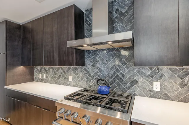 a kitchen with a stove and a cabinet with wooden floor