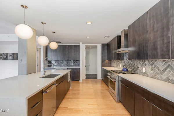 a large kitchen with kitchen island a sink stainless steel appliances and cabinets