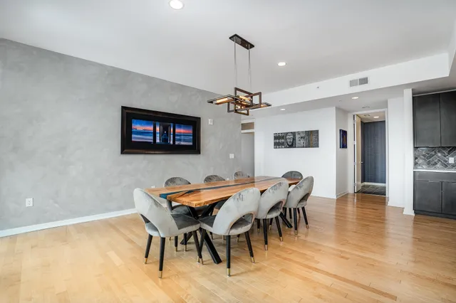 a view of a dining room with furniture and wooden floor