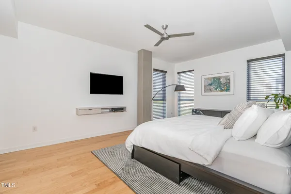 a bedroom with a bed and a flat screen tv