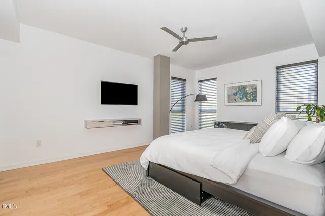 a bedroom with a bed and a flat screen tv