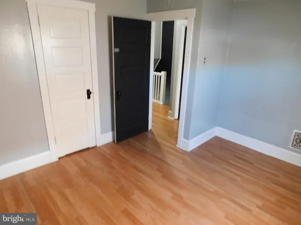 a view of a room with wooden floor and bathroom