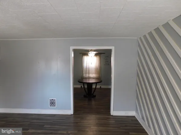 a view of a room with wooden floor table and staircase