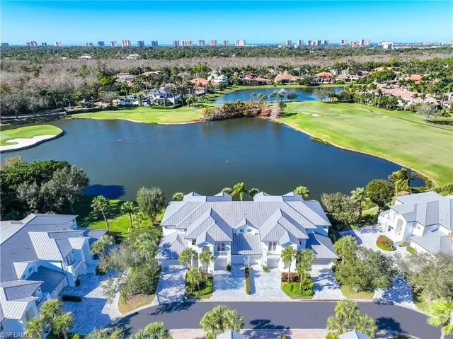 an aerial view of residential houses with outdoor space and river