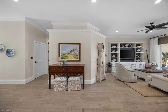 a living room with furniture and large windows