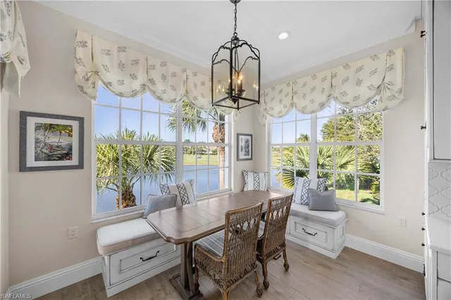 a view of a dining room with furniture and chandelier