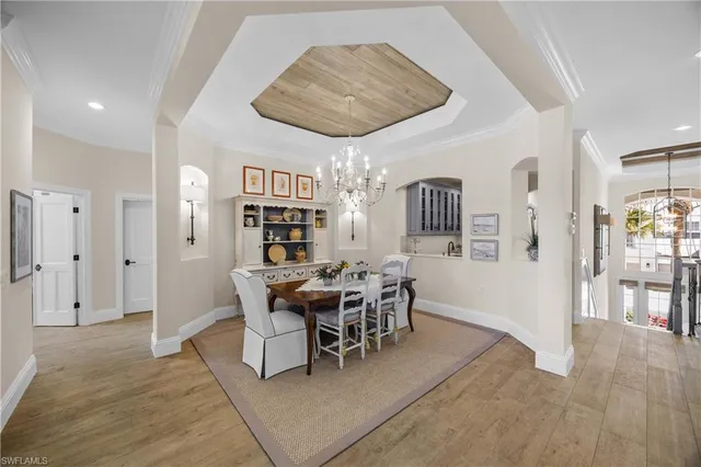 a spacious bedroom with a large bed and a chandelier