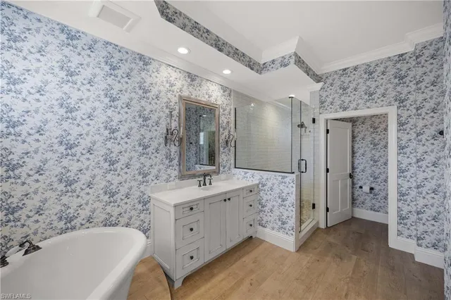 a bathroom with a double vanity sink a toilet a mirror and shower