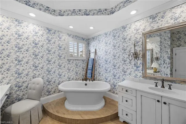 a living room with furniture ceiling fan and a window