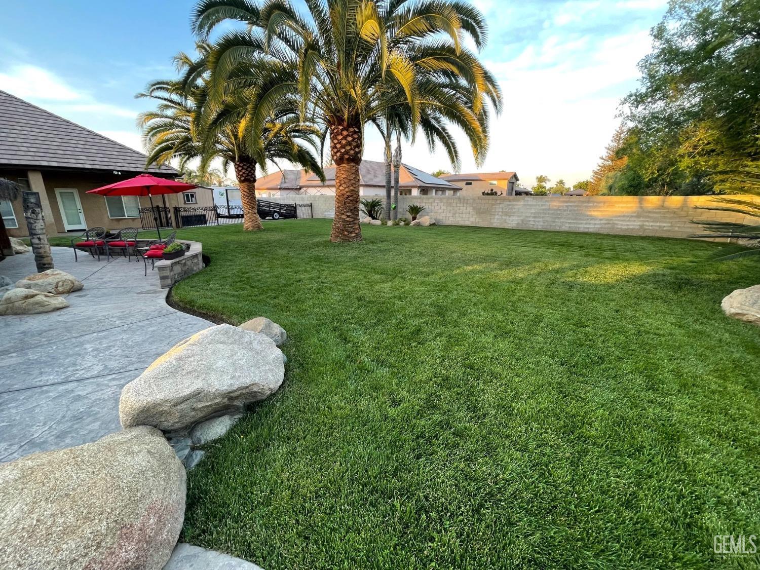 Undisclosed Address Bakersfield, CA 93314 - Photo 11 of 60 a view of backyard with swimming pool and green space
