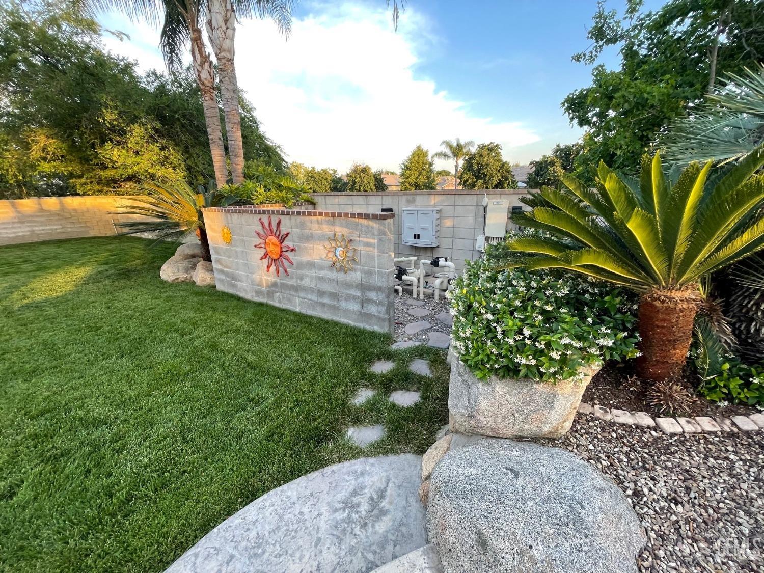 Undisclosed Address Bakersfield, CA 93314 - Photo 12 of 60 a view of a garden with plants and large trees