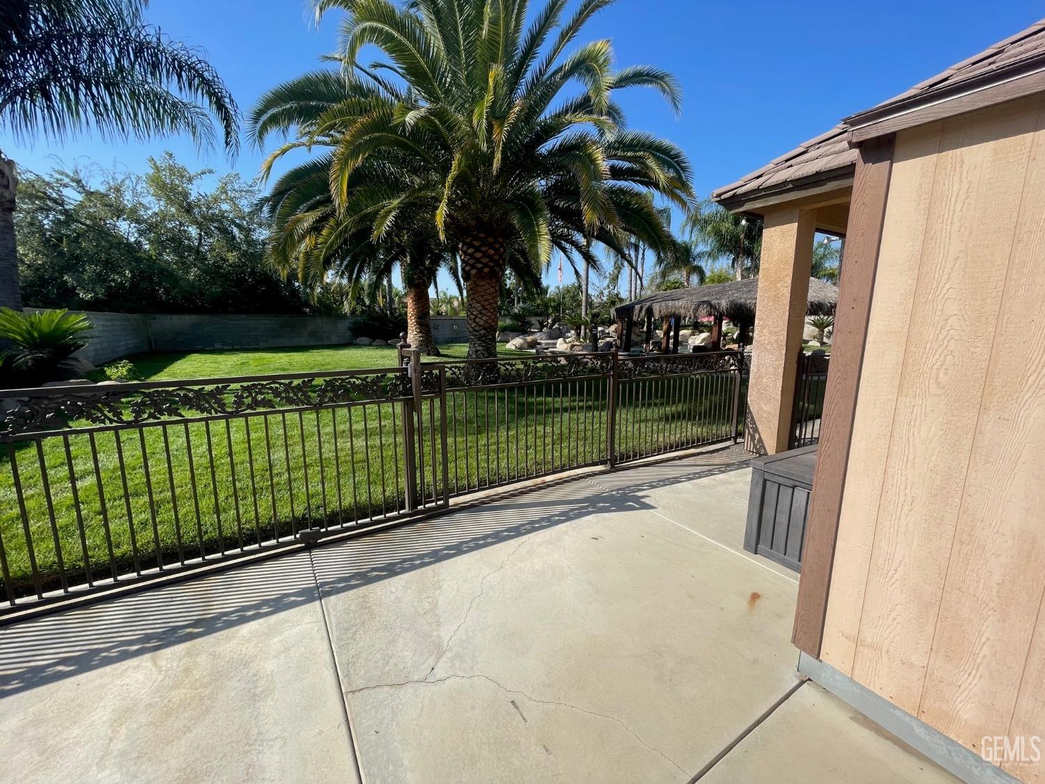 Undisclosed Address Bakersfield, CA 93314 - Photo 24 of 60 a view of swimming pool with a patio and a yard