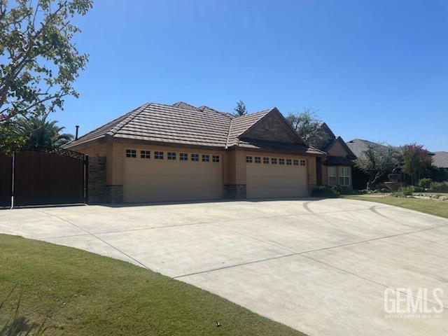 Undisclosed Address Bakersfield, CA 93314 - Photo 3 of 60 a front view of a house with a yard