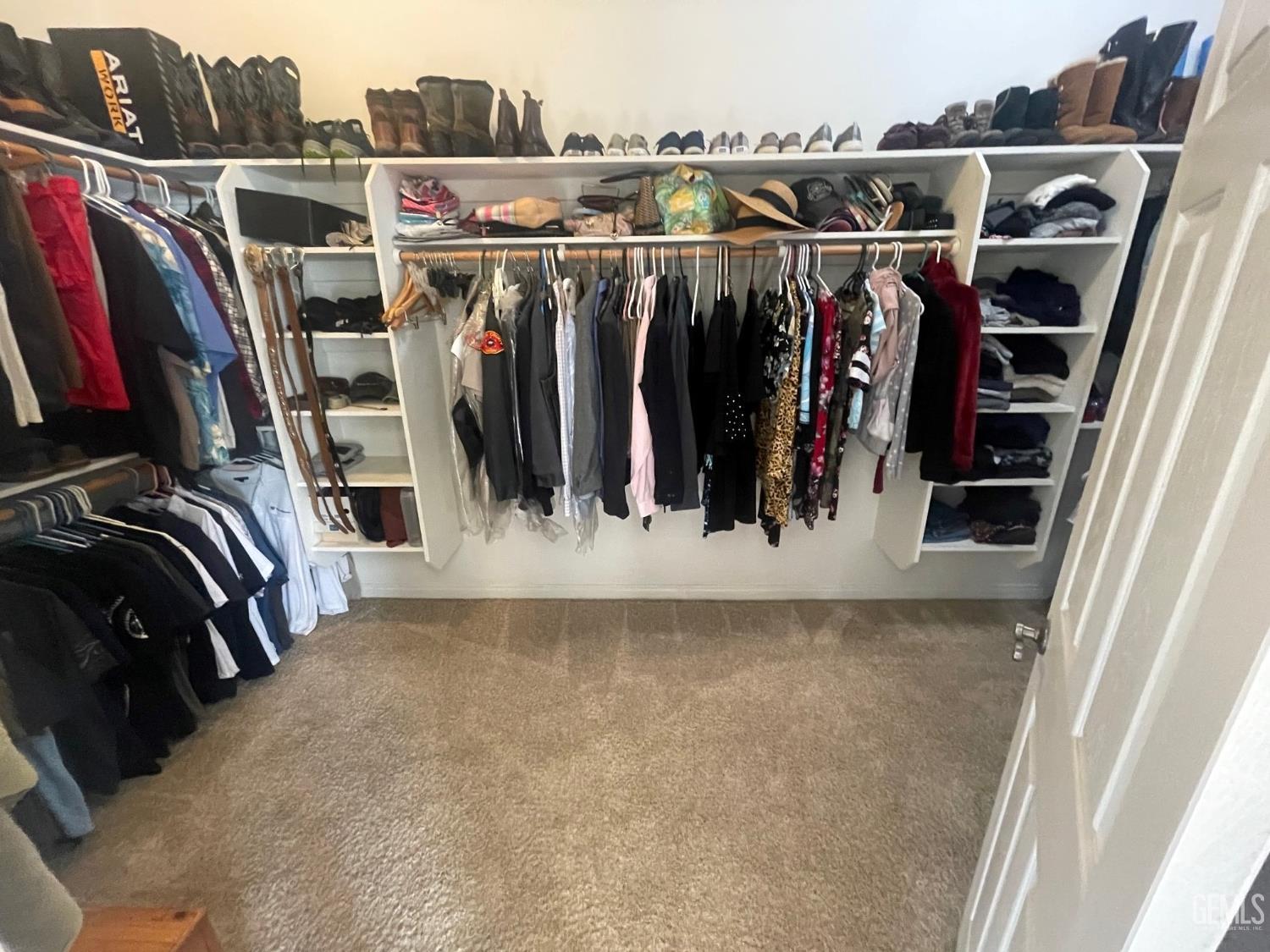 Undisclosed Address Bakersfield, CA 93314 - Photo 32 of 60 a view of walk in closet with clothes and shoes