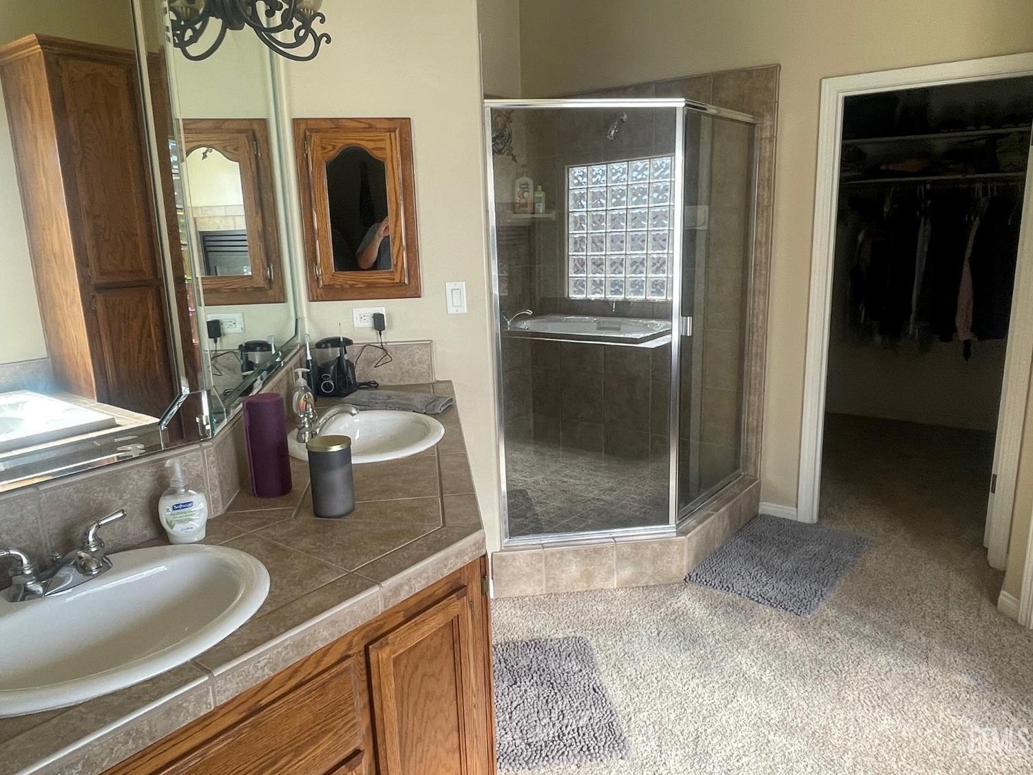 Undisclosed Address Bakersfield, CA 93314 - Photo 33 of 60 a bathroom with sink and mirror