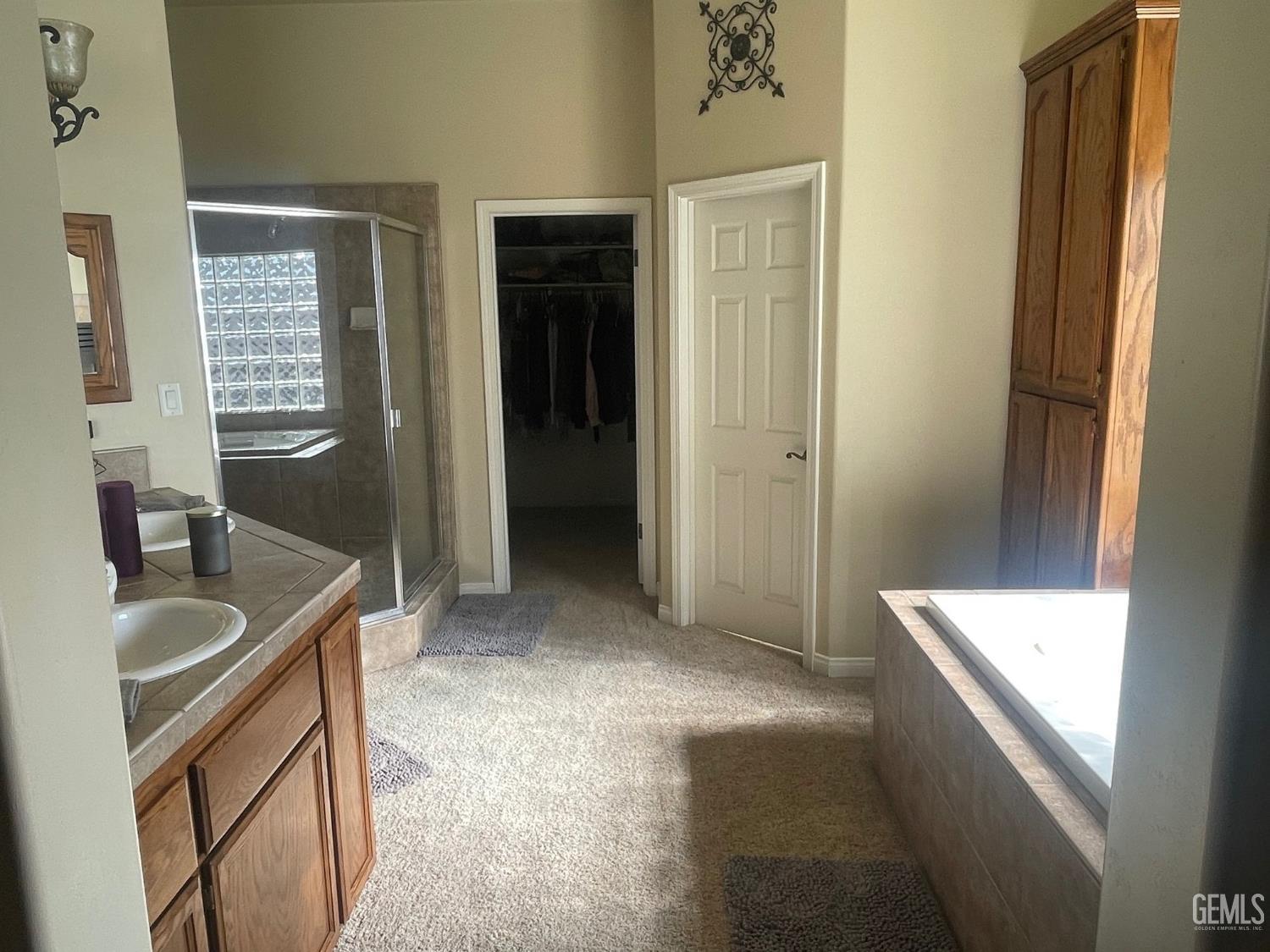 Undisclosed Address Bakersfield, CA 93314 - Photo 35 of 60 a bathroom with a tub sink and mirror