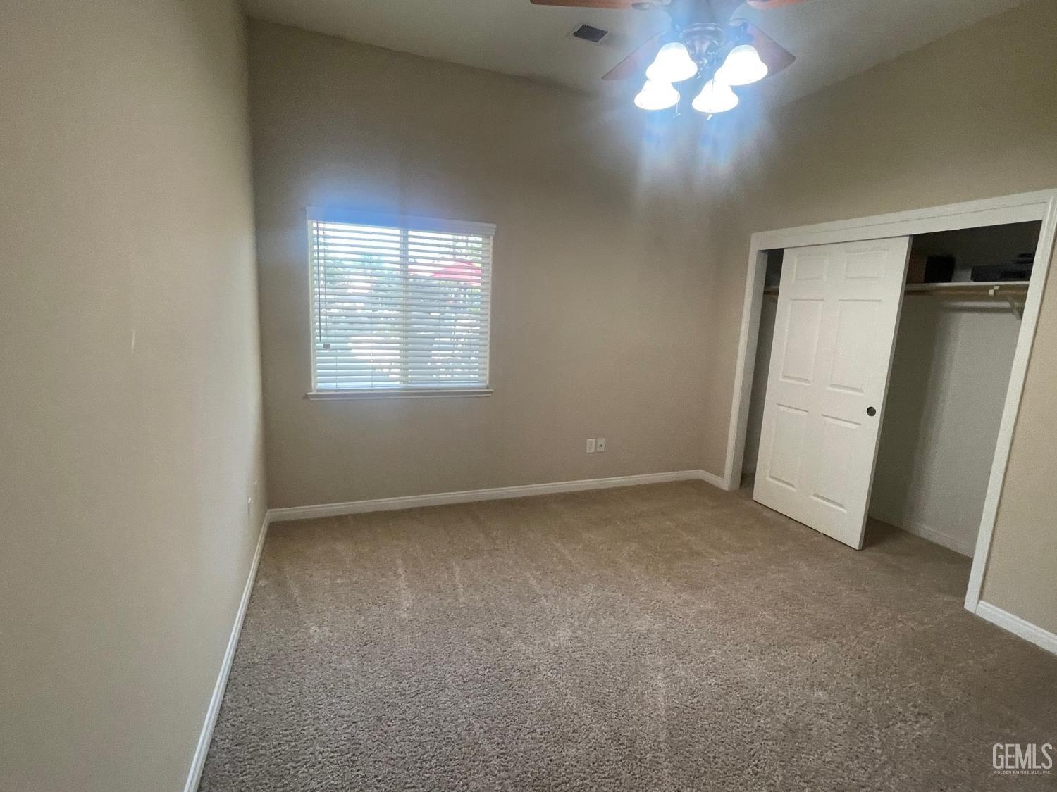 Undisclosed Address Bakersfield, CA 93314 - Photo 39 of 60 an empty room with a windows and a fan