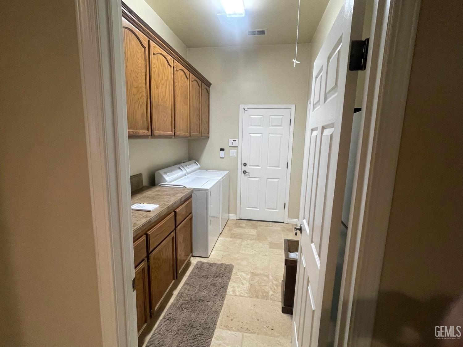 Undisclosed Address Bakersfield, CA 93314 - Photo 46 of 60 a bathroom with a sink a washer and dryer