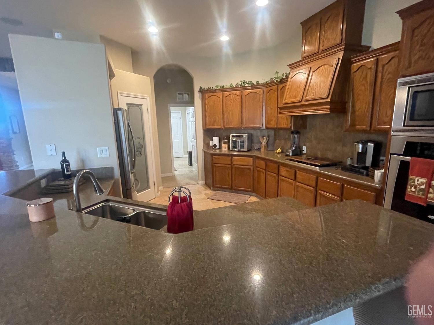 Undisclosed Address Bakersfield, CA 93314 - Photo 48 of 60 a kitchen with stainless steel appliances a sink a stove and a microwave