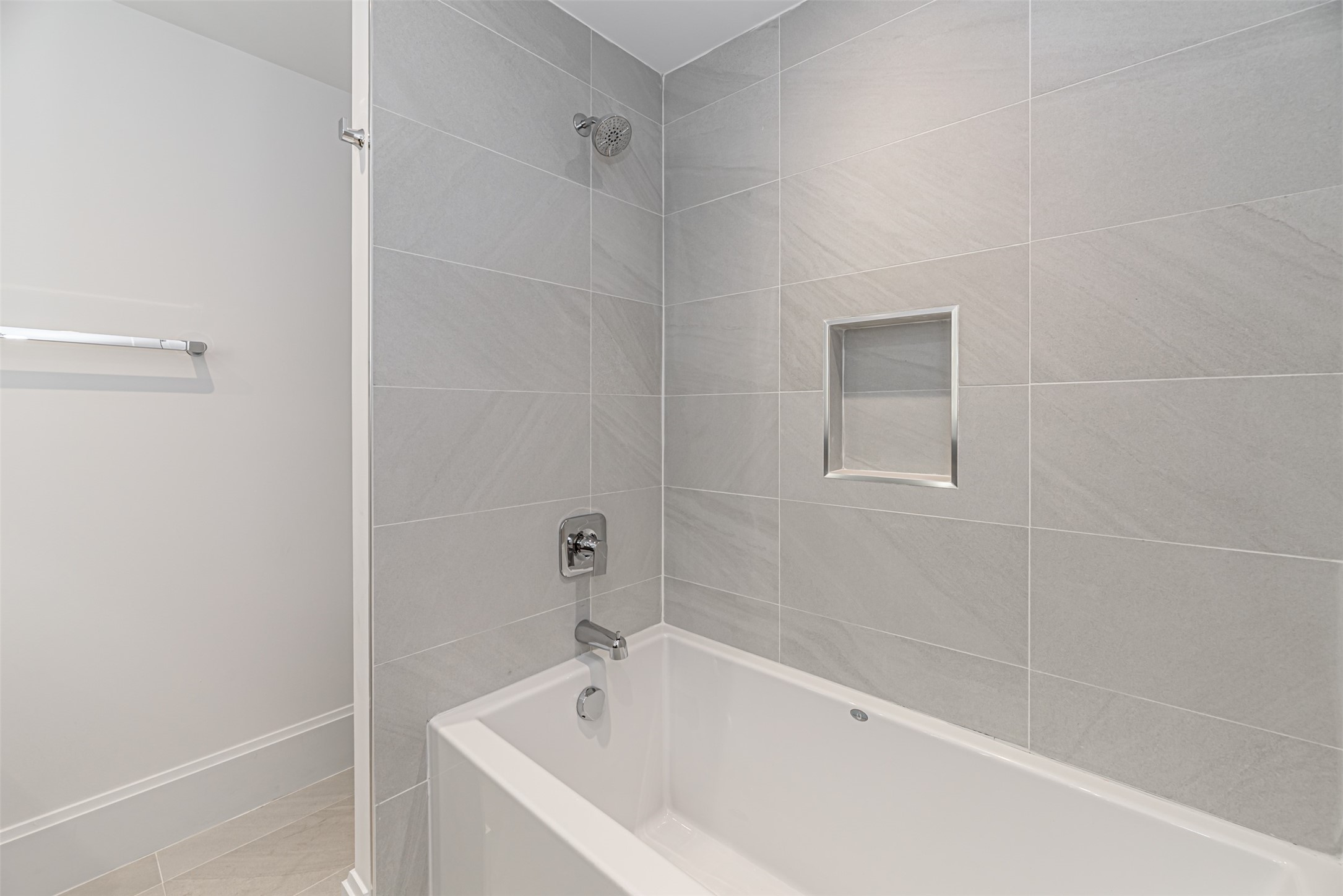 1701 Hermann Drive, Unit 34L Houston, TX 77004 - Photo 20 of 37 There is a luxurious deep soaker tub - shower combination finished elegantly with a soap niche.