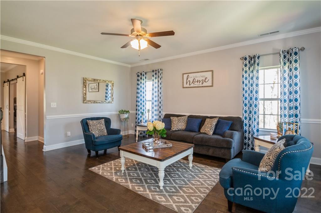 5113 Unionville Road Monroe, NC 28110 - Photo 11 of 43 a living room with furniture a chandelier and a window