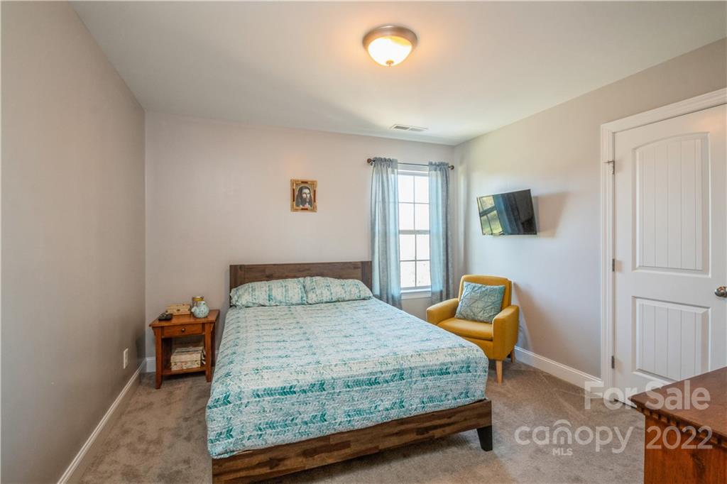 5113 Unionville Road Monroe, NC 28110 - Photo 20 of 43 a bedroom with a bed and wooden floor