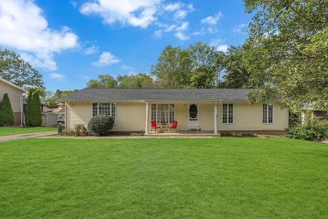 a front view of house with yard and green space