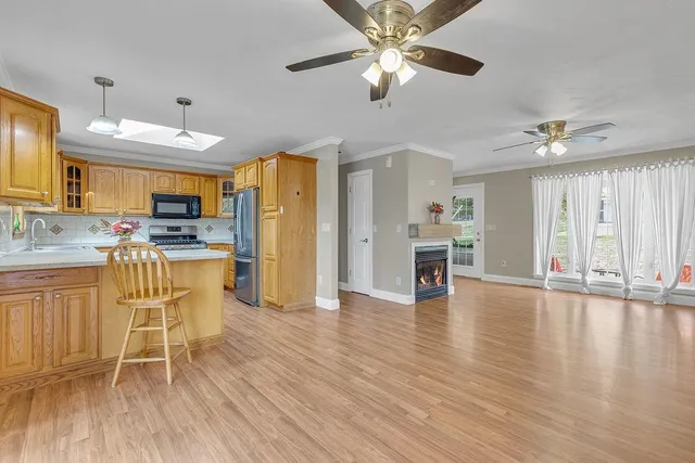 a view of a kitchen with furniture and wooden floor