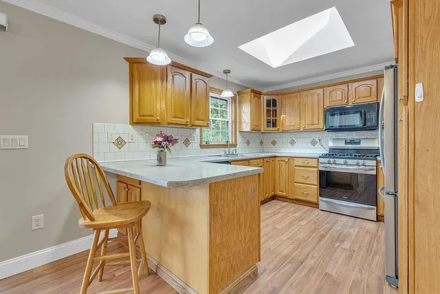 a kitchen with a stove a sink and a refrigerator