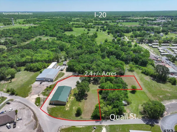an aerial view of residential house with outdoor space and trees all around