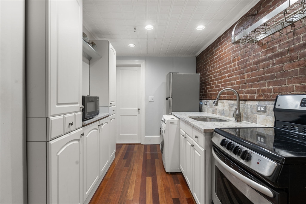 167 Beacon Street, Unit 2 Boston, MA 02116 - Photo 13 of 18 a kitchen with a sink stove and refrigerator