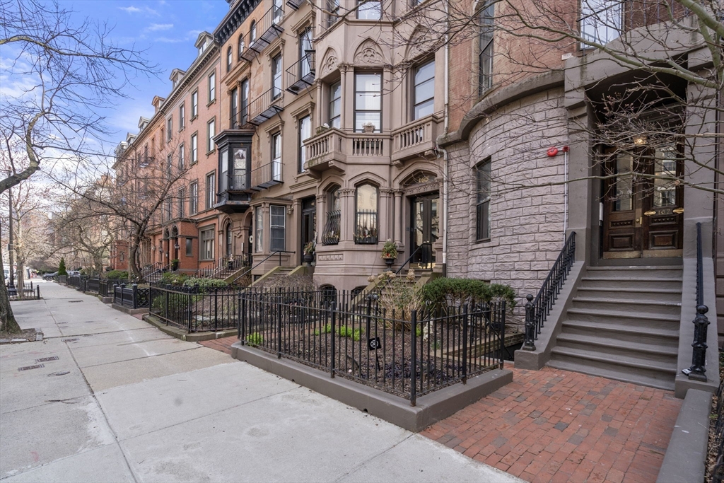 167 Beacon Street, Unit 2 Boston, MA 02116 - Photo 16 of 18 a view of a brick building with many windows