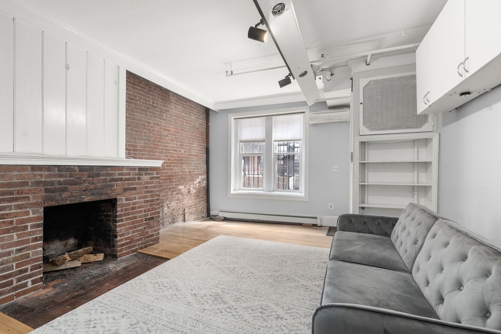 167 Beacon Street, Unit 2 Boston, MA 02116 - Photo 4 of 18 a living room with furniture and a fireplace