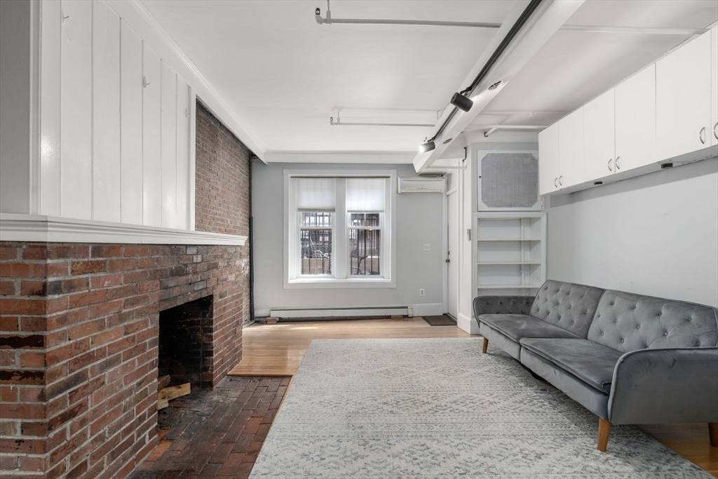167 Beacon Street, Unit 2 Boston, MA 02116 - Photo 5 of 18 a living room with furniture and a fireplace