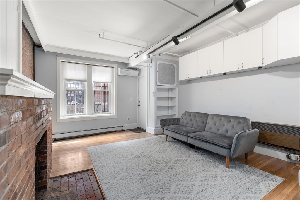 167 Beacon Street, Unit 2 Boston, MA 02116 - Photo 6 of 18 a living room with furniture and a fireplace