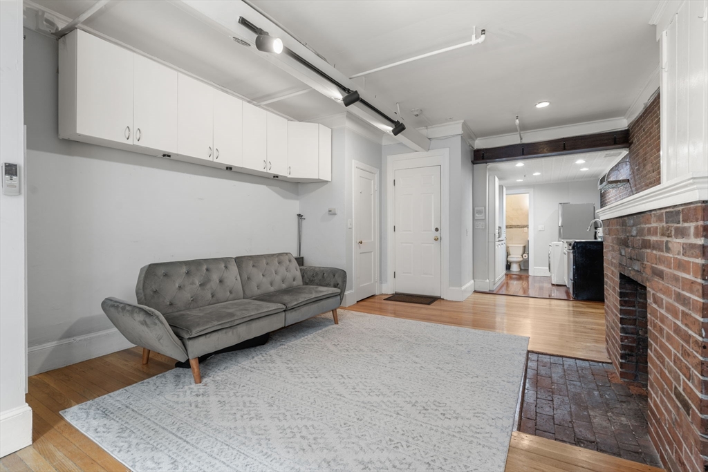 167 Beacon Street, Unit 2 Boston, MA 02116 - Photo 8 of 18 a living room with furniture and a fireplace