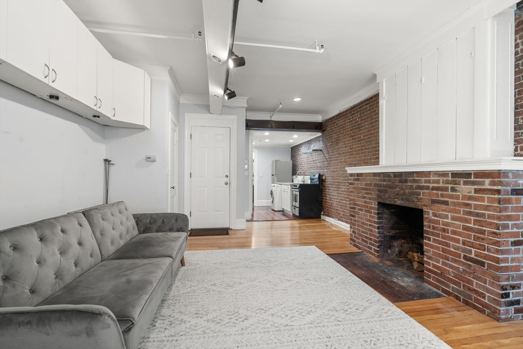 167 Beacon Street, Unit 2 Boston, MA 02116 - Photo 9 of 18 a living room with furniture and a fireplace