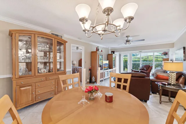 a view of a dining room with furniture large windows and wooden floor