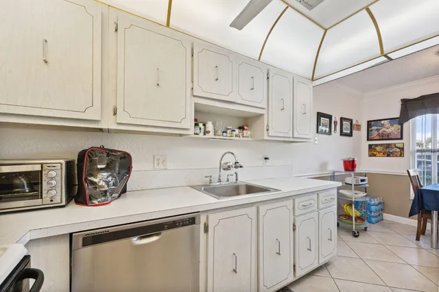 a kitchen with stainless steel appliances granite countertop a sink a stove and cabinets