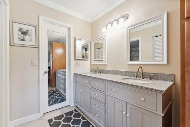 a bathroom with a granite countertop sink mirror and double