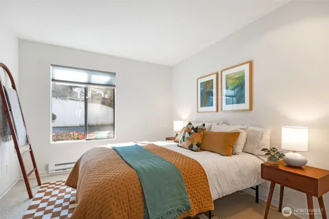 a bedroom with a bed and a lamp with window