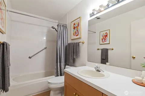 a view of a room that has a bed and a potted plant