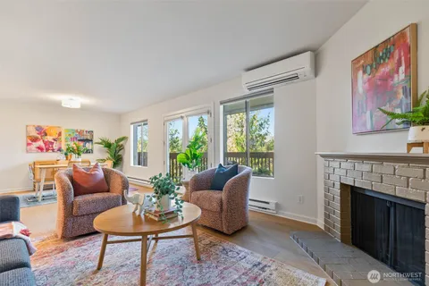 a living room with furniture a window and a fireplace