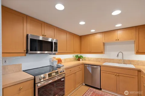 a kitchen with a sink cabinets and appliances