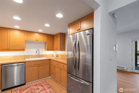 a kitchen with a sink stainless steel appliances and cabinets