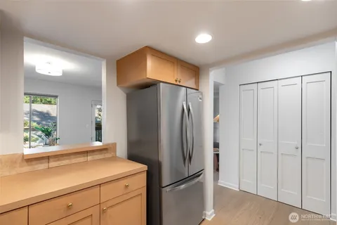 a kitchen with a refrigerator and countertop cabinets