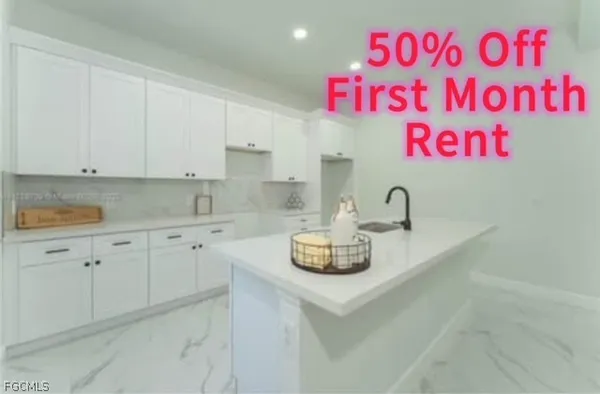 a kitchen with a sink a stove and cabinets